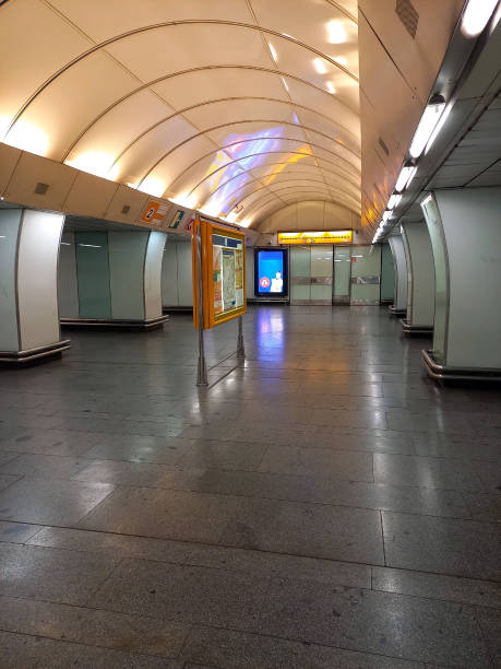 istock Brightly lit empty underground subway station in perspective. Arched ceiling and information board 1767483567
