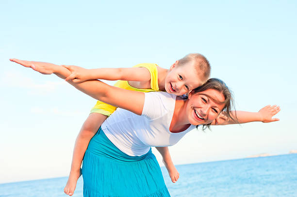 istock mother and son sitting on her back, happy playing 176749299