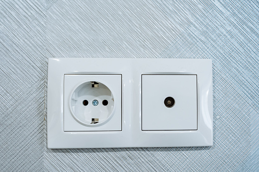 Socket combined with cable socket TV, electrical socket, socket installed on the wall in the room, white design of the panel on the plug of the electrical appliance. High quality photo