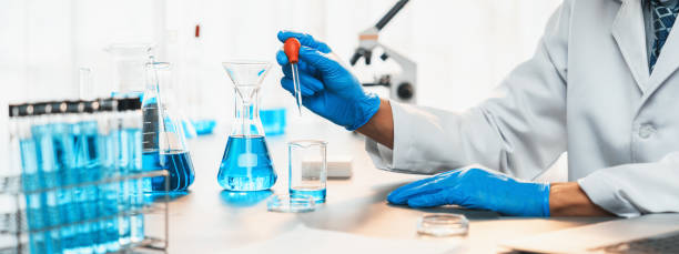 istock Scientist drop precise amount of liquid from pipette into test tube. Neoteric 1767510941