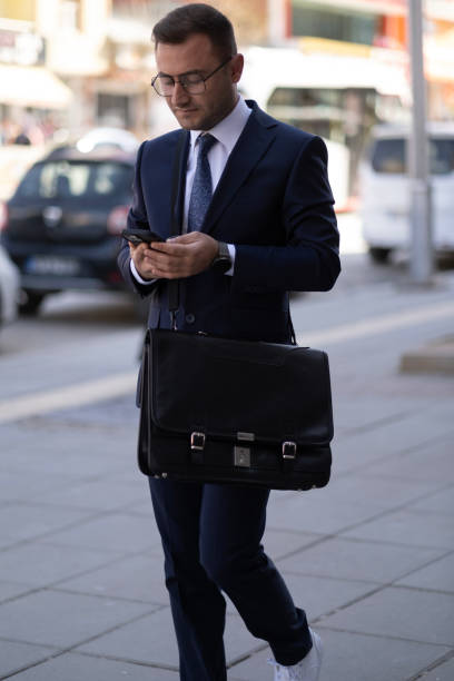 istock Young businessman walking down city street 1767511263