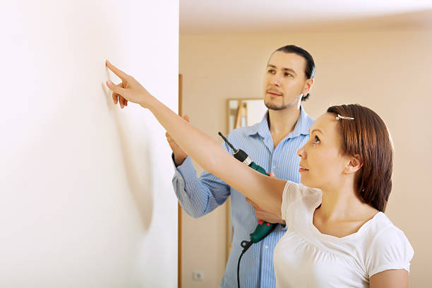 istock Middle-aged couple choosing point for hole in  wall 176751337