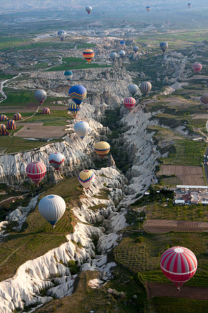 Hot air balloons rise over valley in Cappadocia, Turkey stock photo