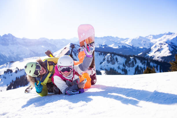 istock two girls with ski and snowboard posing on snow 1767523491