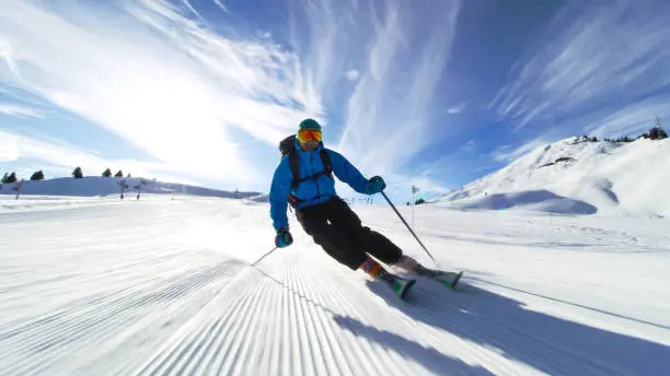 Photo of professional skier skiing on slopes in the Swiss alps towards the camera