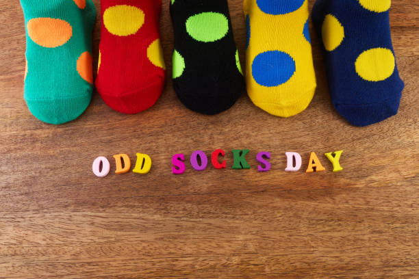 istock Odd Socks Day. Day lost socks, lonely socks on wooden background. 1767545094