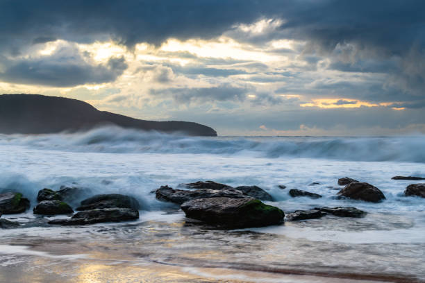 istock Sunrise seascape with low clouds and waves 1767547341