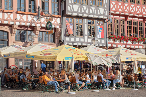 Frankfurt, Germany - September 27, 2023. People eat at patio restaurants in Römerberg, downtown Frankfurt.