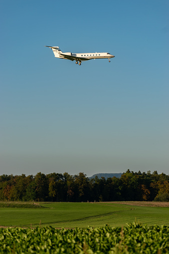 Airplane taking off from the airport runway at night. 3d rendering of a commercial flight taking off from an illuminated airstrip