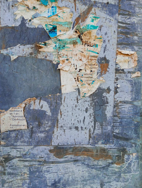 istock Weathered torn ads poster glued to a wall. Abstract grunge background. 1767553993