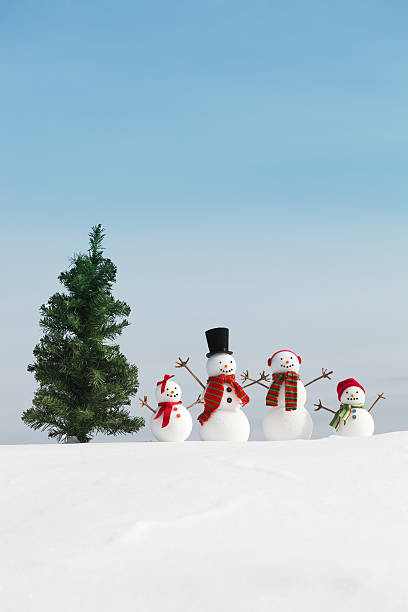 istock Snowman Family with Christmas Tree Vertical and Copy Space 176755604