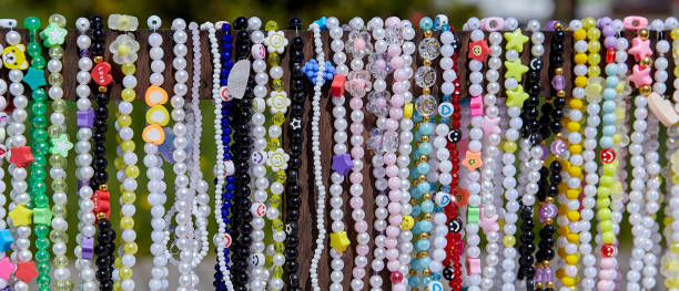 black pearl beads on pink background, copy space