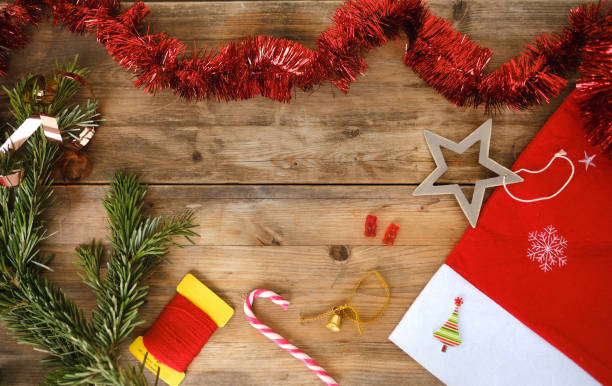 istock festive ambiance with Christmas decorations and sweets, New Year layout for card with space for text, greetings, wooden retro style, Christmas tinsel, candy 1767569678