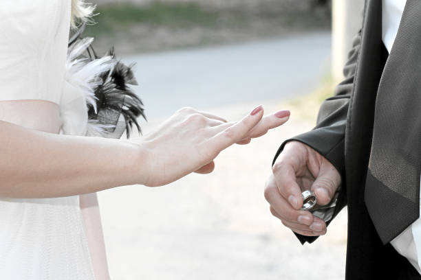 istock married couple holding hands with rings 176761100