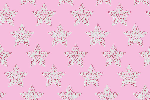 White ornament star on pink background. Christmas composition. Holiday pattern.
