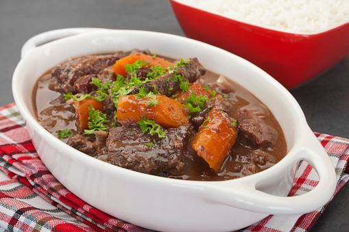 A French stew, daube of beef Provencal has a delicious sauce made from red wine, stock, cinnamon, cloves, orange and herbs. Here it is served with rice.