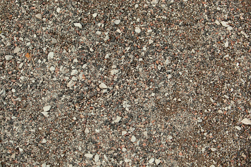 Small seas with gray-colored stones. Asphalt. Texture. Background. For text Tallinn