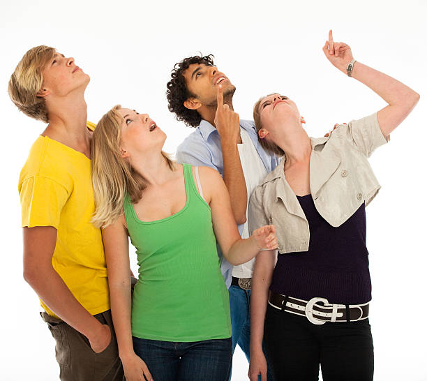 istock Four young adults looking and point up 176761564