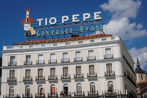 Madrid, Spain - September 10th, 2023: Flats in Puerto del Sol in Madrid, with the famous Tio Pepe sign on top. Puerto del Sol is at the very heart of the city and is a major tourist attraction.