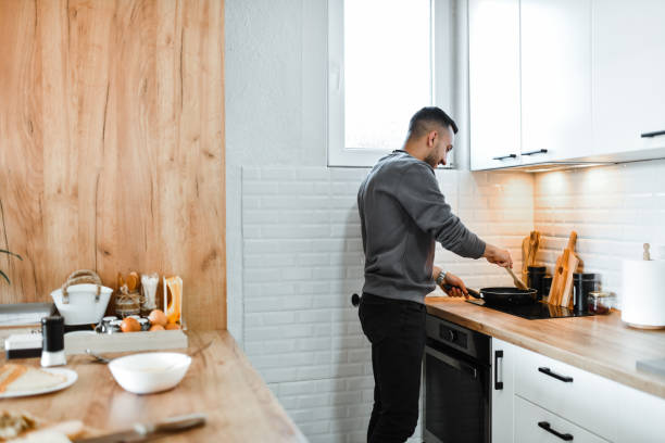 istock Side View Of Male Cook Making Omelette At Home 1767617578