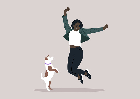 A female pet owner jumping with their Jack Russell puppy, both filled with happiness and excitement