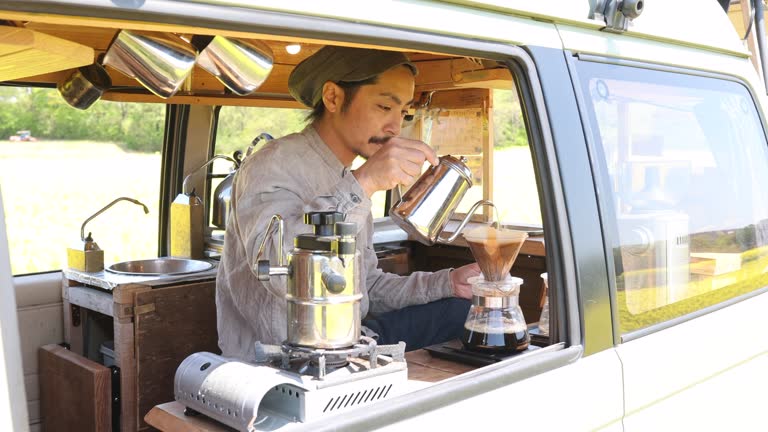 Man pouring coffee in his mobile coffee cafe van