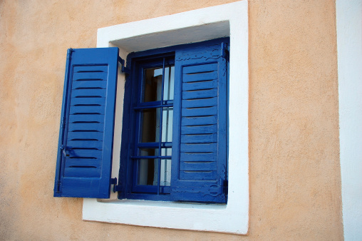 A typical Greek window with blue shades.