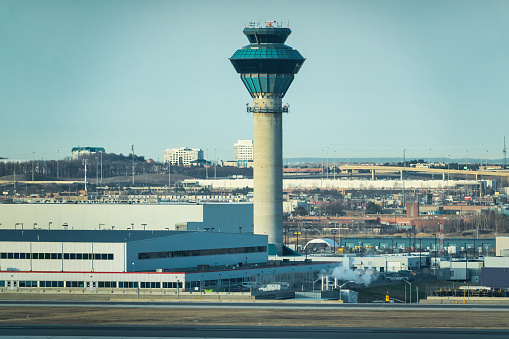 airport control tower and airplane taking off at sunset