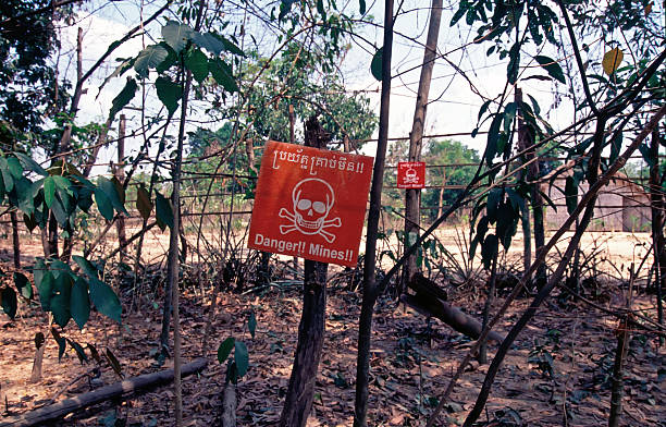 Danger Mines Warning Sign at a danger minefield in Cambodia land mine stock pictures, royalty-free photos & images