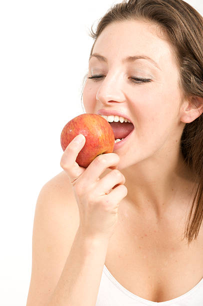 istock woman eating an apple 176765738