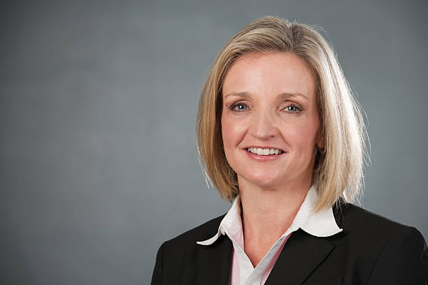 istock Business Woman Headshot with Gray Background 176765780