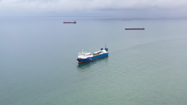 Aerial view of Ro-Ro ship approaching to a commercial port.