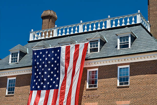 istock Colonial Revival Style Building with Large American Flag Blue Sky 176766835