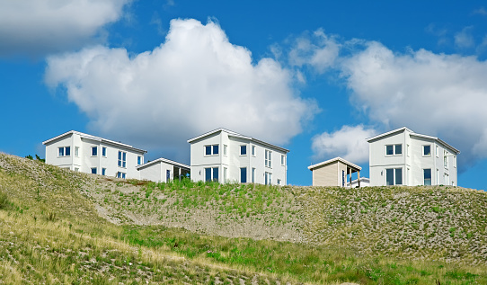 Newly built houses under the blue sky with huge white clouds.