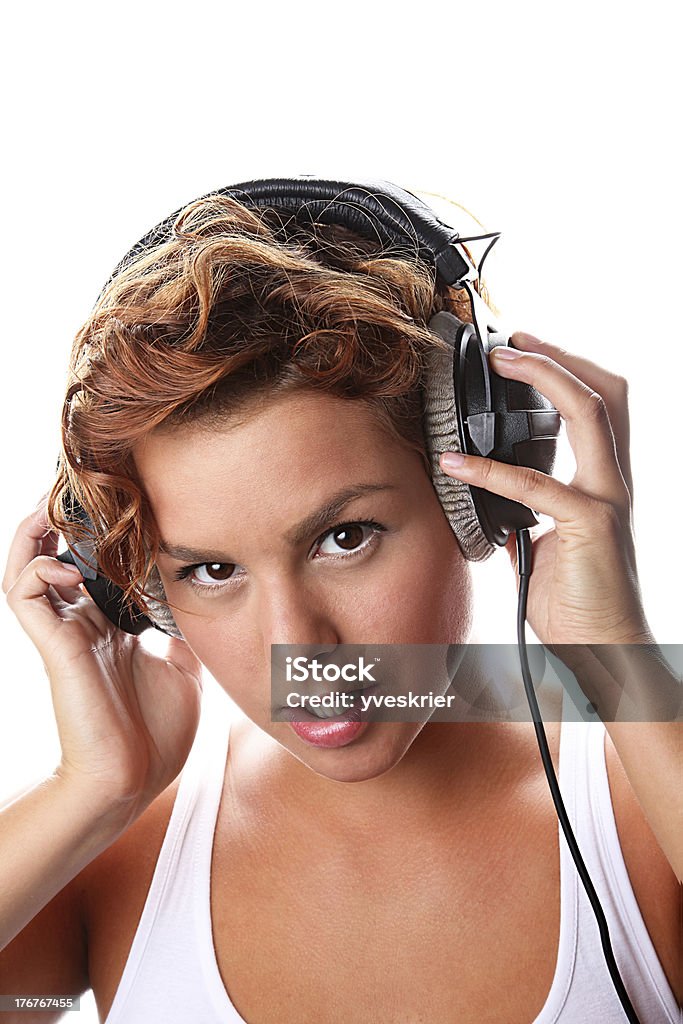young woman with big headphones young woman holds her headphones and listens to music Adult Stock Photo