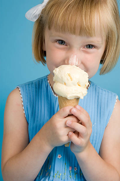 istock Strawberry Blonde Little Girl Eats Ice Cream Cone 176767533