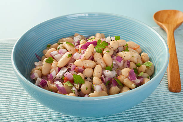 Bowl of fresh bean salad with purple onion stock photo