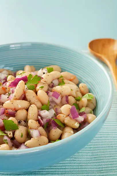 "Italian cannelini bean salad of beans in lemon vinaigrette with red onion, rosemary, parsley and garlic."