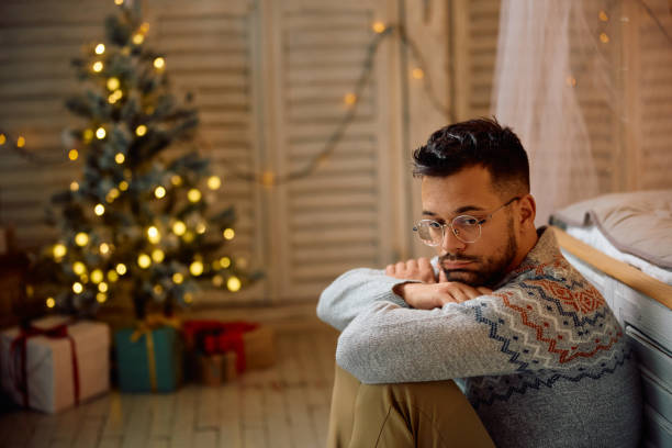istock Pensive man feeling sad while being alone at home for Christmas. 1767687447