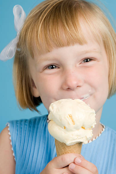 istock Strawberry Blonde Little Girl Eats Ice Cream Cone 176769052