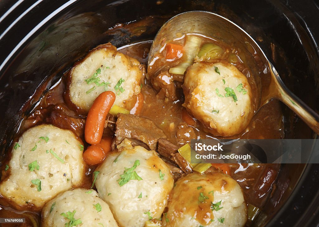 Beef Stew with Dumplings Slow-cooked beef stew with suet dumpings in a casserole dish Beef Stock Photo