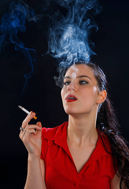 istock woman with cigarette in cloud of smoke 176769285