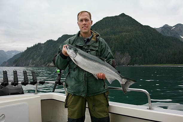 istock Fisherman in Alaska with big silver salmon 176769309