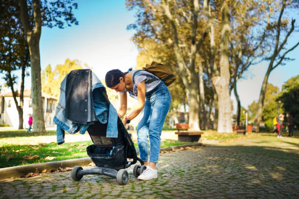 istock Young mother with her daughter sitting on strollers 1767701629