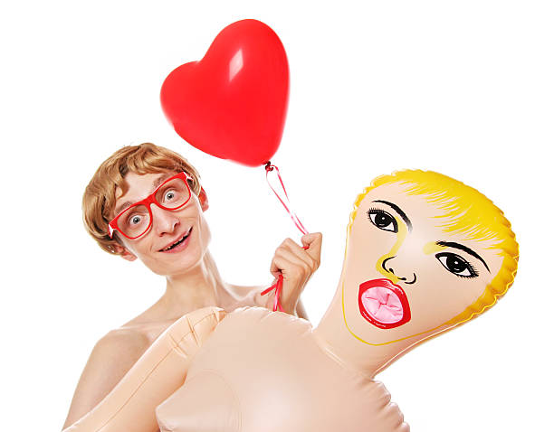 Cheerful nerd with blow up girlfriendmore nerds available: blow up doll stock pictures, royalty-free photos & images