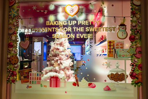 London, England, United Kingdom - December 17, 2022: Illuminated holiday decor store window displays during the Christmas season
