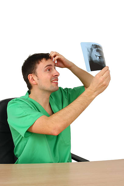 Doctor looking at x-ray (isolated on white) stock photo