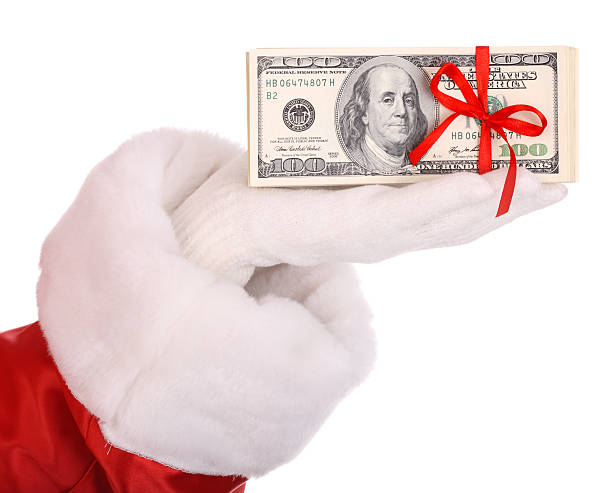Money dollar in hand of santa claus. stock photo