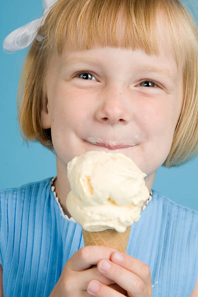 istock Strawberry Blonde Little Girl Eats Ice Cream Cone 176772358