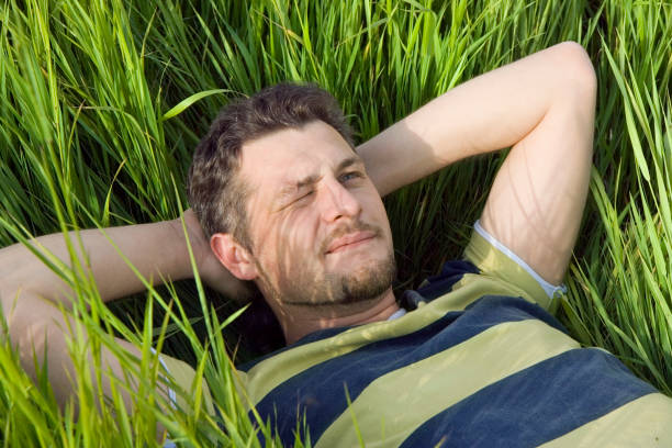 istock The man lies on a grass 176774019
